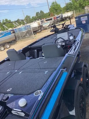 Slide: The Image of The image shows a 2026 Bass Cat Lynx STS boat with gray seats and blue accents. - 49