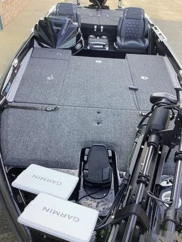 Slide: The Image of The image shows the deck of a 2026 Bass Cat Lynx STS with gray carpeting and Garmin equipment. - 25