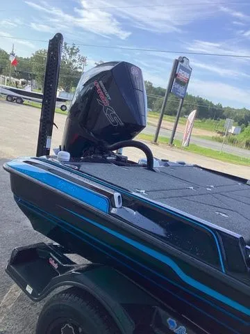 Slide: The Image of A Bass Cat Lynx STS boat with a powerful outboard motor, parked on a trailer. - 35