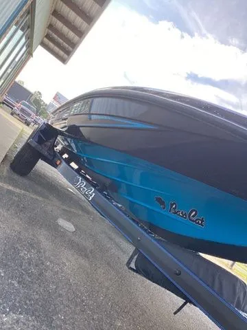 Slide: The Image of A 2026 Bass Cat Lynx STS on a trailer, featuring a sleek blue hull. - 28