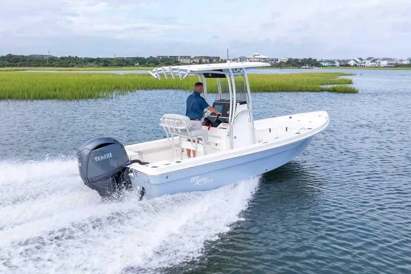 Slide: The Image of Manufacturer Provided Image: 2025 Bay Rider 219 Bay boat cruising on a scenic waterway with lush greenery. - 1
