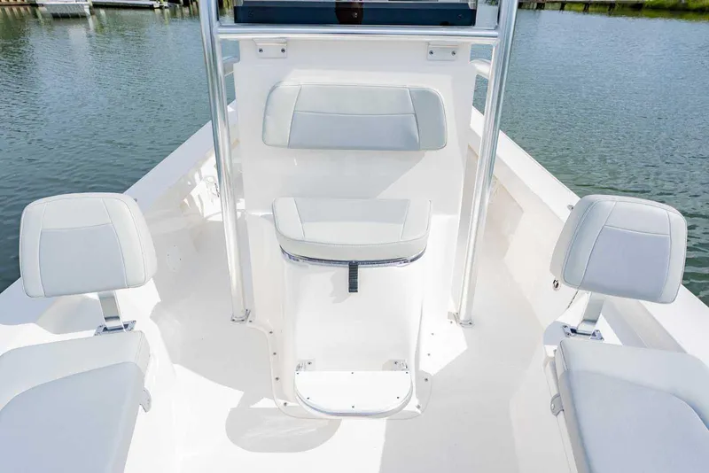 Slide: The Image of 2026 Bay Rider 219 Bay boat interior with white seating and console on water. - 9