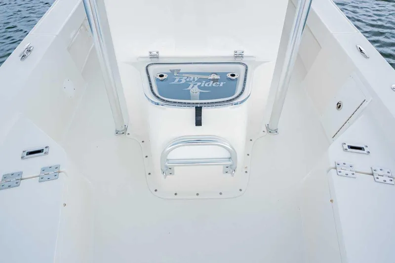 Slide: The Image of 2026 Bay Rider 219 Bay boat interior with storage compartment and sleek design. - 11