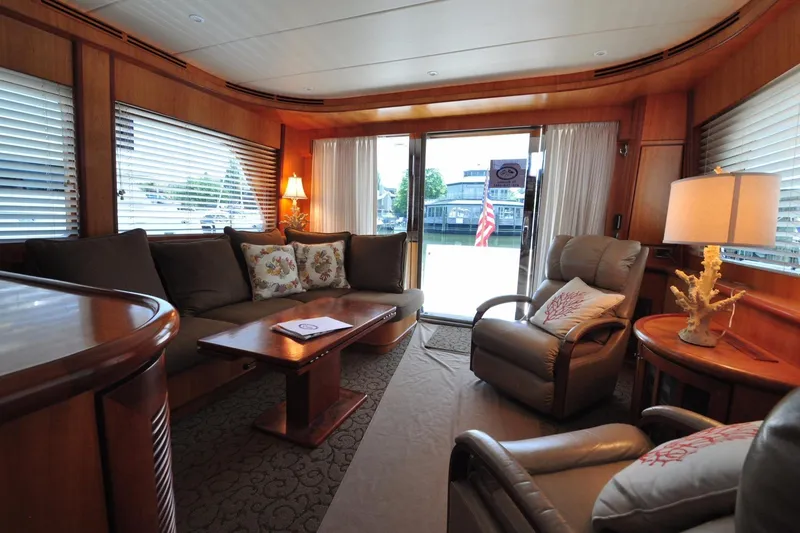 Slide: The Image of Luxurious yacht interior with plush seating, wooden accents, and large windows, Symbol 56, 2003 model. - 10