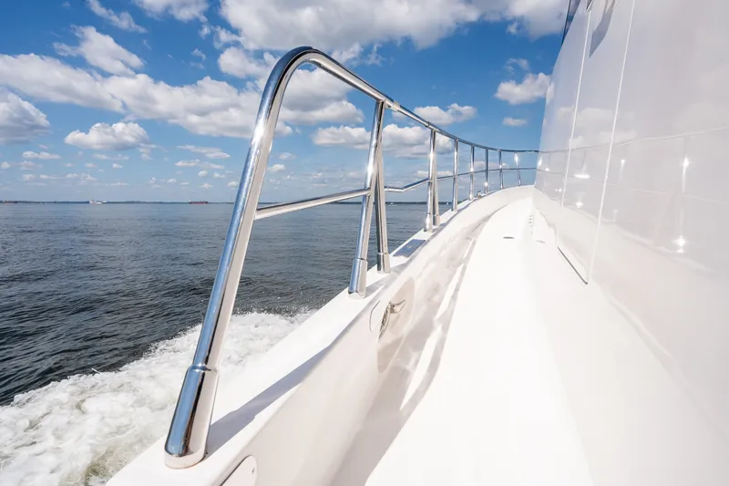 Slide: The Image of Sleek 2003 Symbol 56 yacht cruising on open water under a partly cloudy sky. - 21
