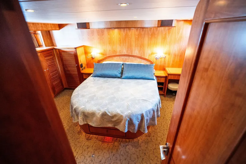 Slide: The Image of Luxurious wooden cabin interior with a cozy bed on a 2003 Symbol 56 yacht. - 77