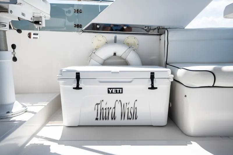 Slide: The Image of White YETI cooler labeled "Third Wish" on a boat deck, Symbol 56, 2003. - 43