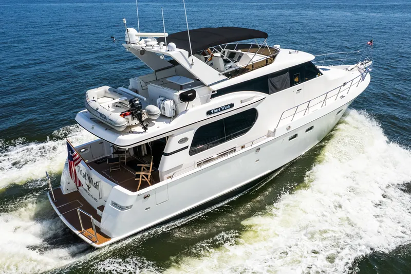 Slide: The Image of Luxurious 2003 Symbol 56 yacht cruising on open water, showcasing sleek design and elegance. - 8