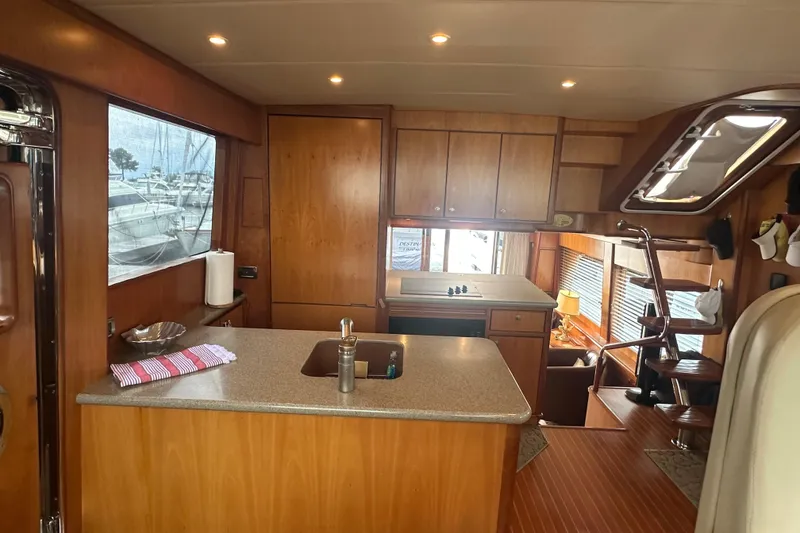Slide: The Image of Luxurious yacht interior with wooden cabinetry, modern kitchen, and staircase, Symbol 56, 2003 model. - 39