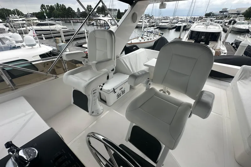 Slide: The Image of Luxury yacht cockpit with two white captain chairs, marina view, Symbol 56, 2003 model. - 8