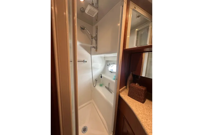 Slide: The Image of Compact yacht bathroom with shower, vanity, and storage in a 2003 Symbol 56 model. - 51