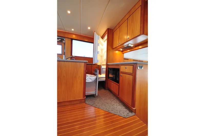 Slide: The Image of Luxurious wooden interior of a 2003 Symbol 56 yacht kitchen area. - 14