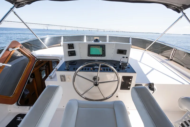 Slide: The Image of Helm of 2003 Symbol 56 yacht with steering wheel and navigation equipment, overlooking the ocean. - 27