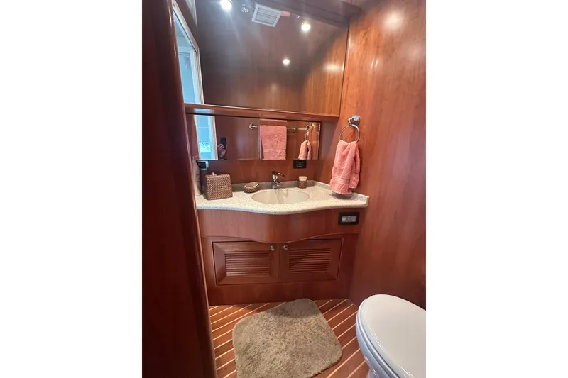 Slide: The Image of Luxurious wooden bathroom interior on a 2003 Symbol 56 yacht, featuring elegant fixtures and decor. - 50