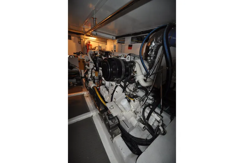 Slide: The Image of Engine room of a 2003 Symbol 56 yacht, showcasing mechanical components and piping. - 31