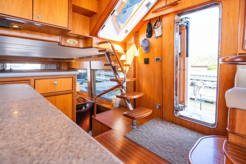 Slide: The Image of Luxurious yacht interior with wooden finishes, spiral staircase, and modern design, Symbol 56, 2003 model. - 69