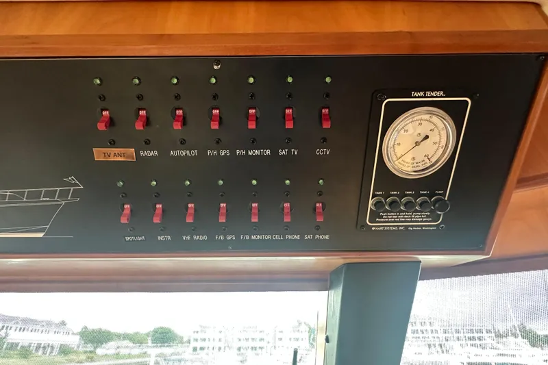 Slide: The Image of Control panel of a 2003 Symbol 56 yacht with switches and tank tender gauge. - 40