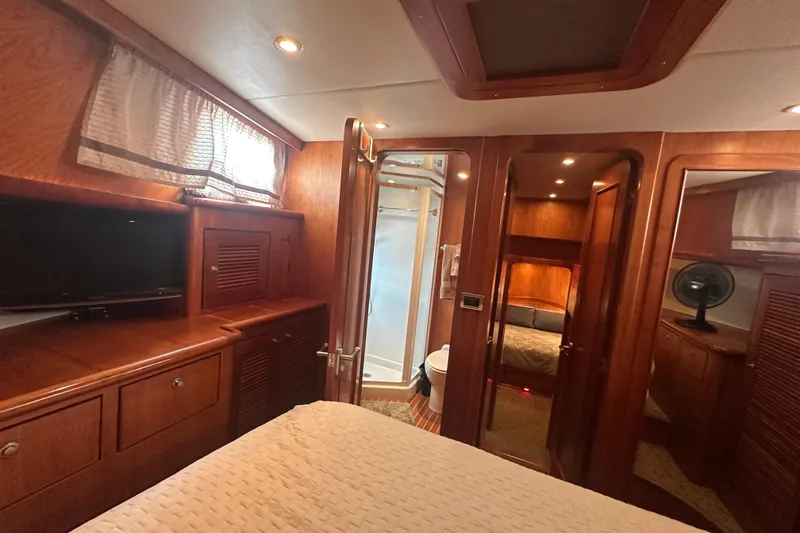 Slide: The Image of Luxurious 2003 Symbol 56 yacht interior with wood finish, bedroom, and bathroom. - 57
