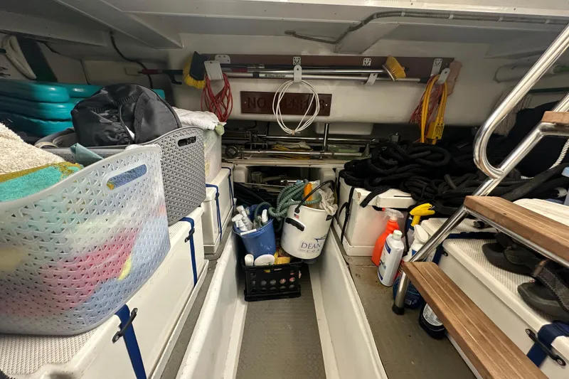 Slide: The Image of Storage area on a 2003 Symbol 56 boat, filled with cleaning supplies and equipment. - 73