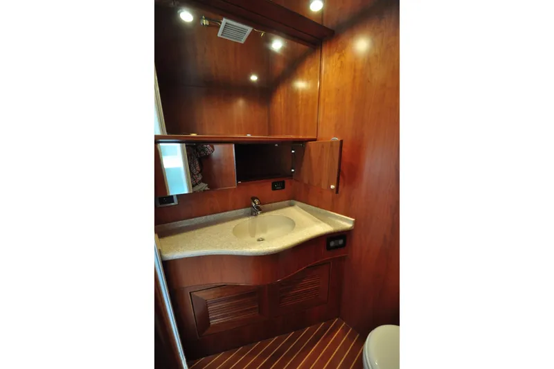 Slide: The Image of Luxurious wooden bathroom interior with sink and mirror in a 2003 Symbol 56 yacht. - 27