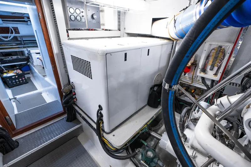 Slide: The Image of Engine room of a 2003 Symbol 56 yacht, featuring machinery and control panels. - 95