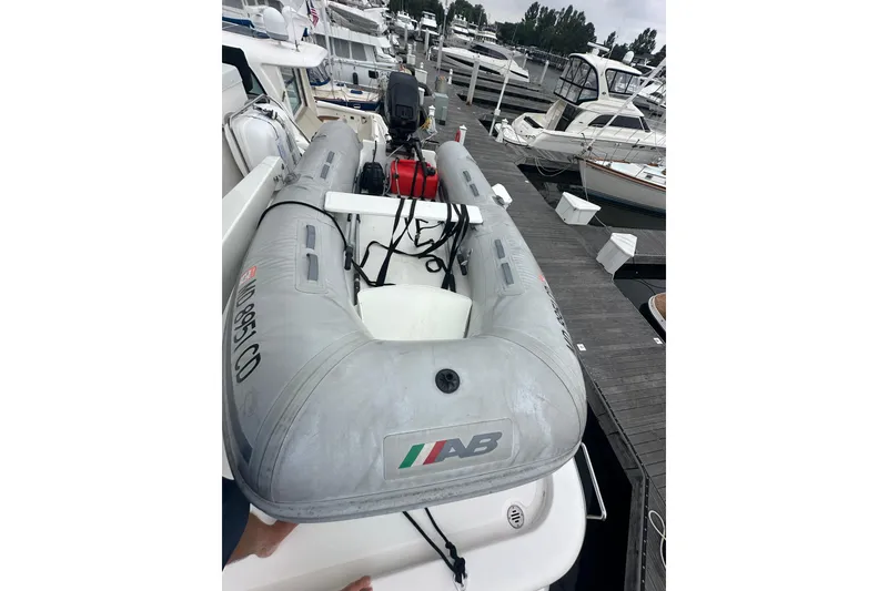 Slide: The Image of Inflatable boat docked at marina, surrounded by various yachts and boats. - 17