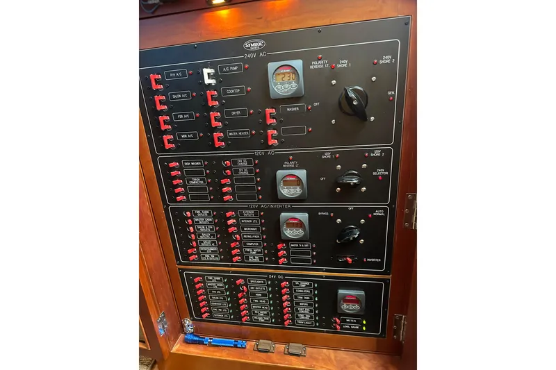 Slide: The Image of Electrical control panel of a 2003 Symbol 56 yacht, featuring switches and meters. - 74