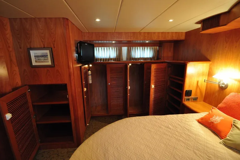 Slide: The Image of Luxurious wooden cabin interior with cozy bed, TV, and ample storage on a 2003 Symbol 56 yacht. - 24