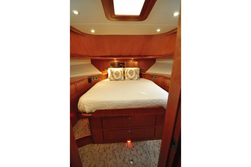 Slide: The Image of Luxurious cabin interior of 2003 Symbol 56 yacht with cozy bed and wooden finish. - 28