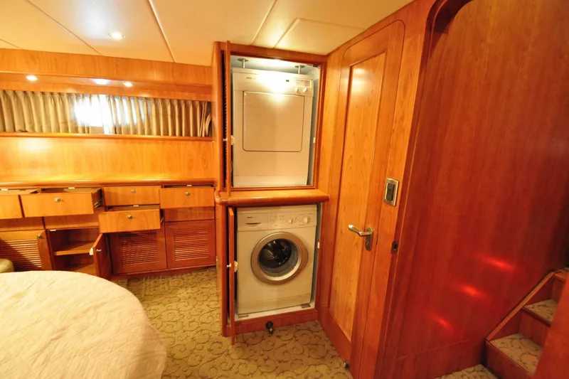 Slide: The Image of Laundry area with stacked washer and dryer in a wooden interior, Symbol 56 yacht, 2003. - 26