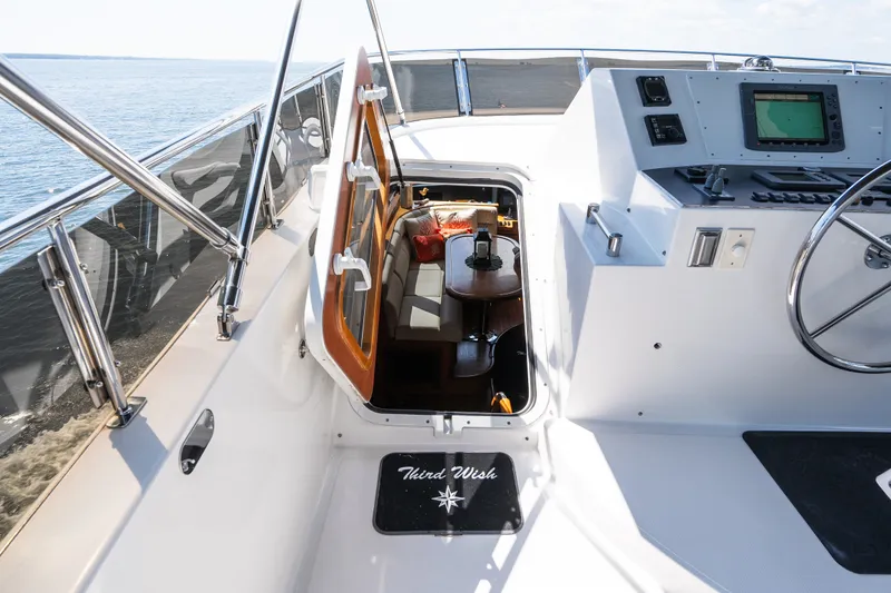 Slide: The Image of Cockpit view of a 2003 Symbol 56 yacht, featuring navigation equipment and cabin entrance. - 26