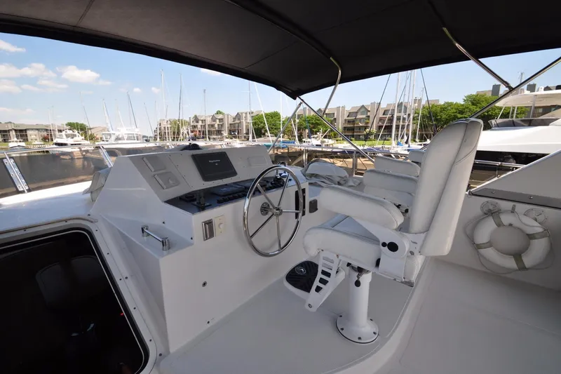 Slide: The Image of Helm of a 2003 Symbol 56 yacht with steering wheel and navigation equipment. - 7