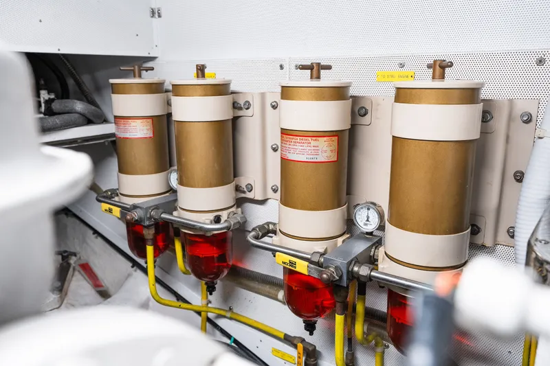 Slide: The Image of Engine room with three fuel filters in a 2003 Symbol 56 model yacht. - 99