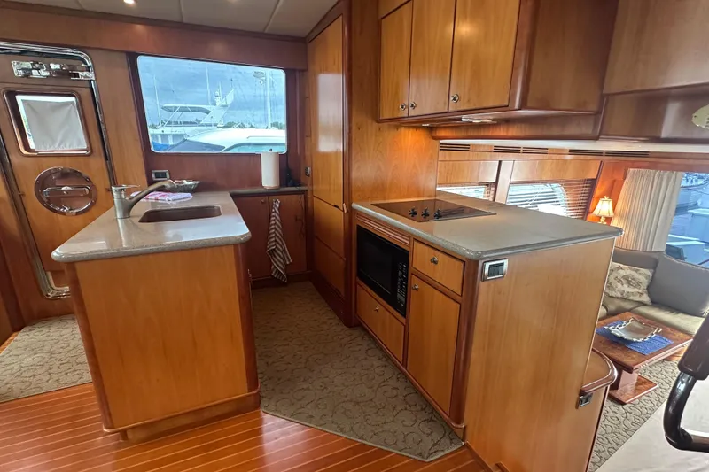 Slide: The Image of Luxurious yacht interior with wooden cabinetry, modern kitchen, and cozy seating area, Symbol 56, 2003. - 33
