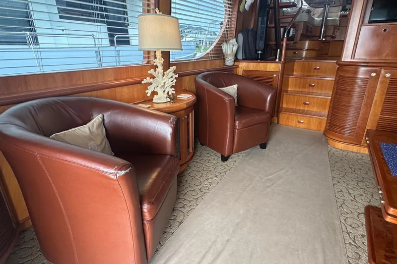 Slide: The Image of Luxurious yacht interior with leather chairs, wooden accents, and elegant decor, Symbol 56, 2003. - 23