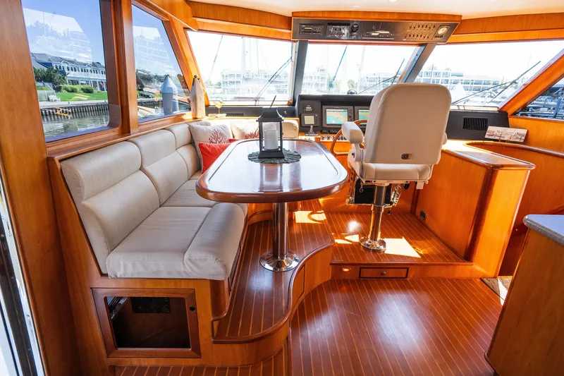 Slide: The Image of Luxurious Symbol 56 yacht interior with plush seating and modern navigation controls, 2003 model. - 61