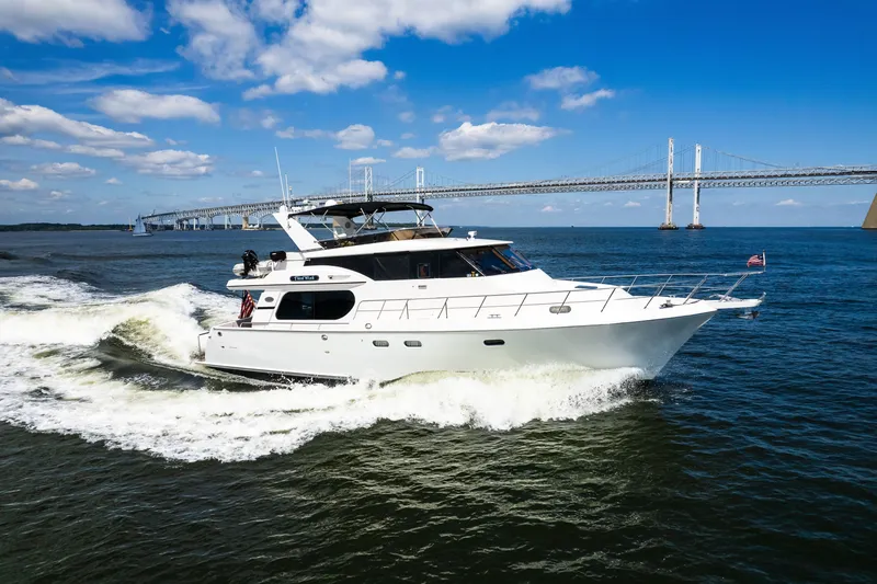 Slide: The Image of Luxury yacht Symbol 56 cruising near a bridge under a clear blue sky. - 4