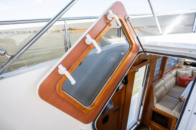 Slide: The Image of Open hatch on a 2003 Symbol 56 yacht, revealing interior with seating. - 24