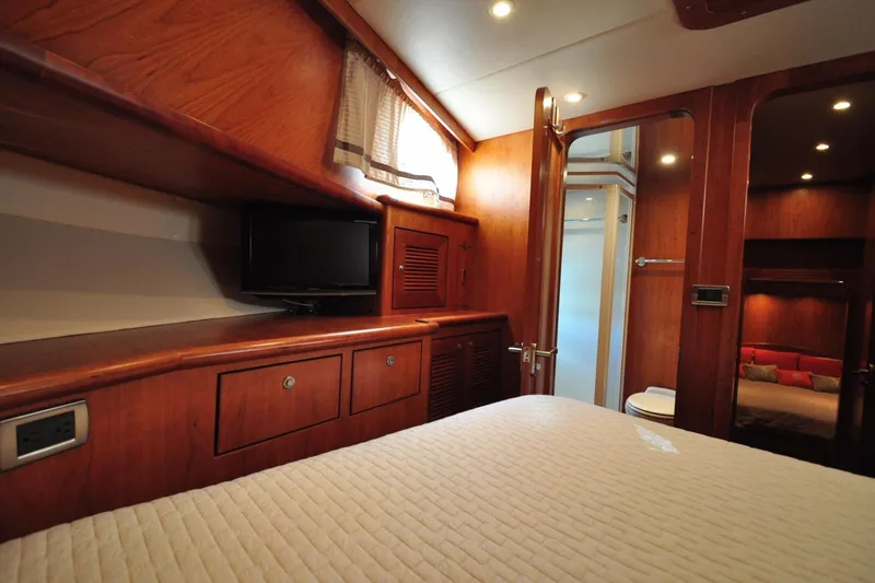 Slide: The Image of Luxurious yacht cabin interior with wood paneling, TV, and cozy bedding, Symbol 56, 2003 model. - 30