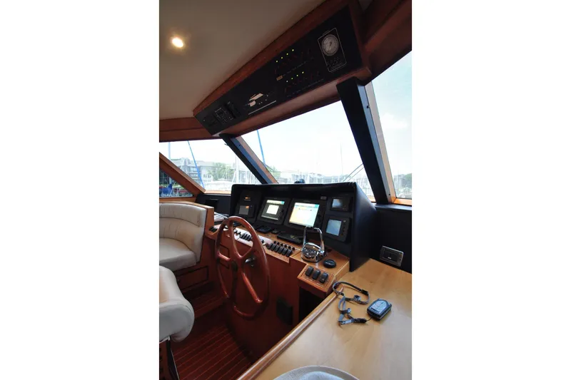 Slide: The Image of Luxurious yacht cockpit interior with steering wheel, navigation screens, and plush seating, Symbol 56, 2003. - 15