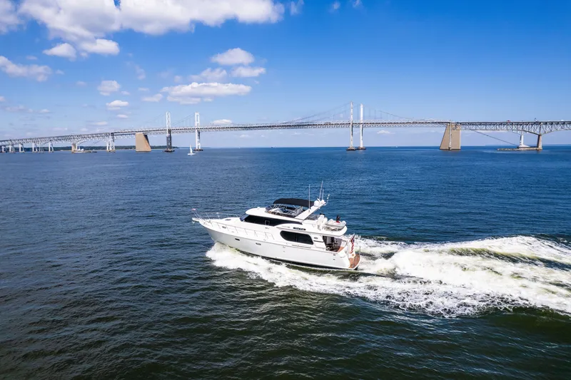 Slide: The Image of Luxury yacht cruising under a bridge on a sunny day, Symbol 56 model, 2003. - 5