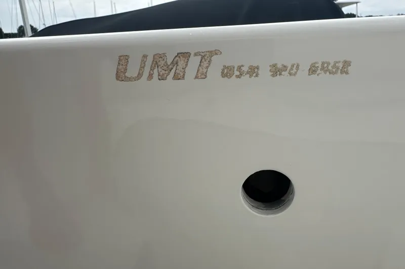 Slide: The Image of Boat hull with faded "UMT USA 2003" text, featuring a circular opening. - 20