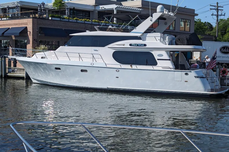 Slide: The Image of Luxurious 2003 Symbol 56 yacht docked near waterfront buildings. - 3