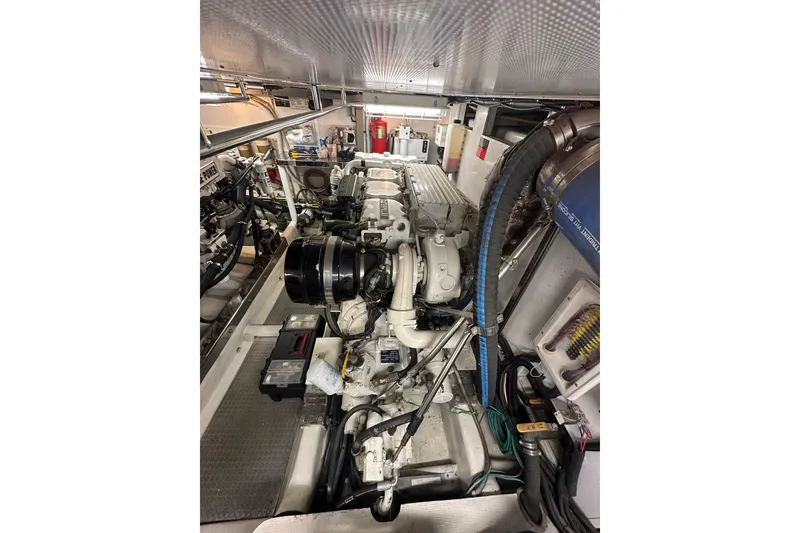 Slide: The Image of Engine room of a 2003 Symbol 56 yacht, showcasing mechanical components and systems. - 61