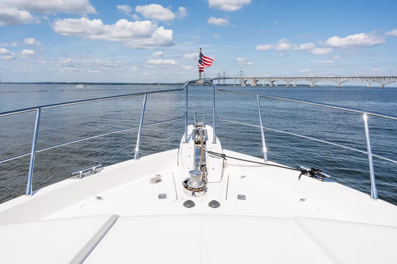 Slide: The Image of Bow view of 2003 Symbol 56 yacht with bridge and American flag in background. - 19