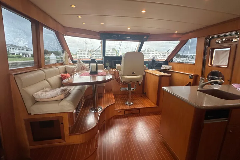 Slide: The Image of Luxurious interior of a 2003 Symbol 56 yacht with elegant wood finishes and plush seating. - 32