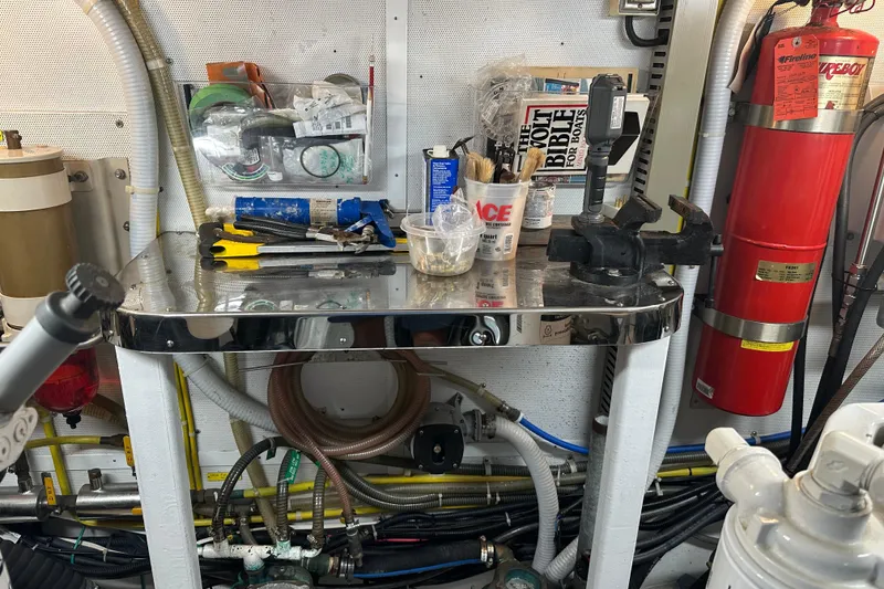 Slide: The Image of Workshop with tools, fire extinguisher, and equipment on a metal table, Symbol 56, 2003. - 62