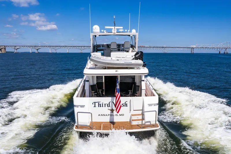 Slide: The Image of Luxury yacht "Third Wish" cruising near a bridge, Annapolis, MD, under clear blue skies. - 10