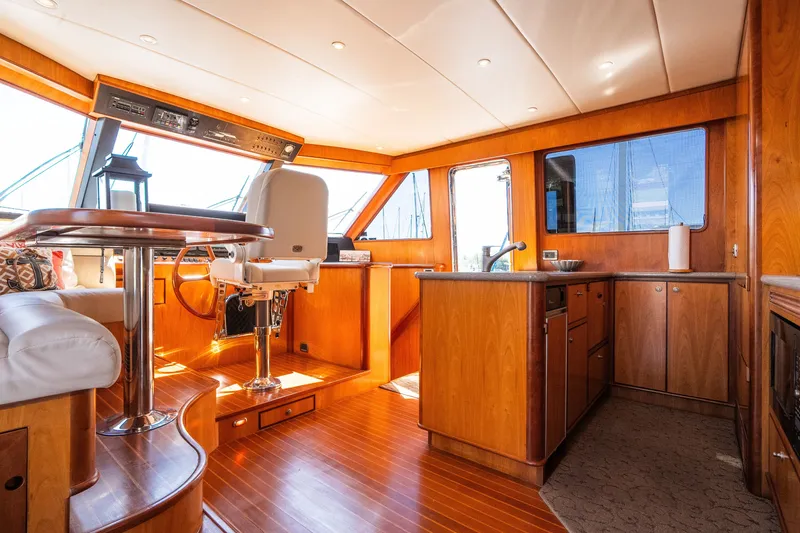 Slide: The Image of Luxurious 2003 Symbol 56 yacht interior with wood finishes and modern helm station. - 60