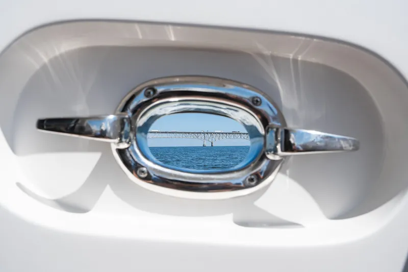 Slide: The Image of Chrome boat handle framing a distant bridge over blue water, Symbol 56, 2003. - 23